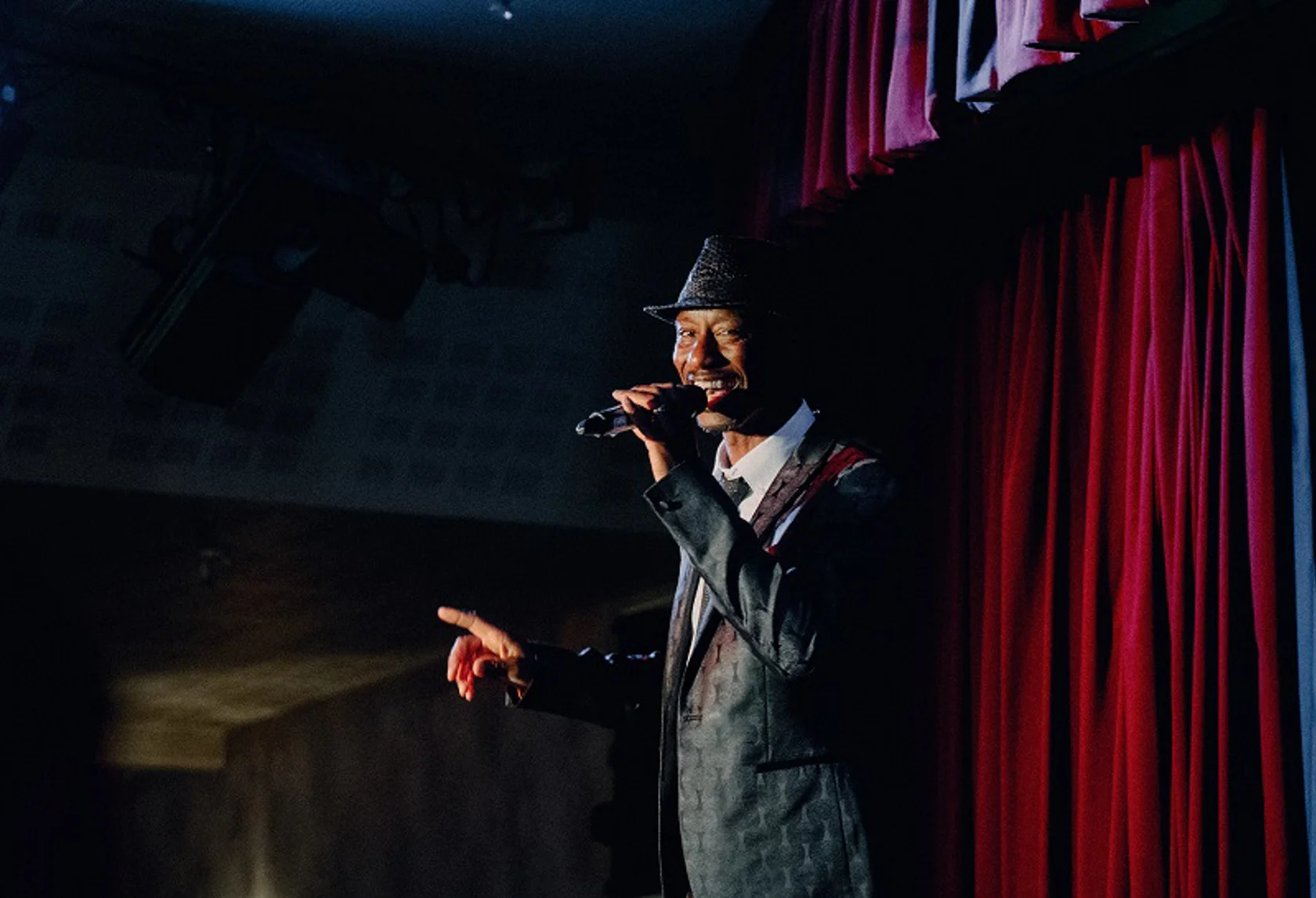 Variety performer on stage with a microphone