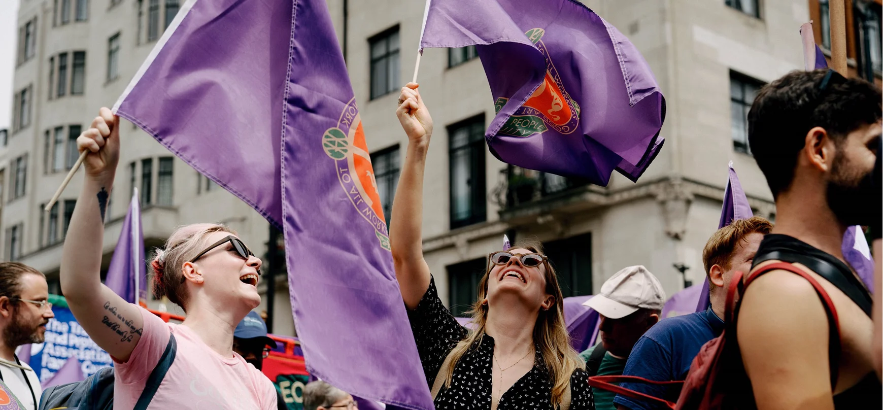 Equity members waving flags at a rally